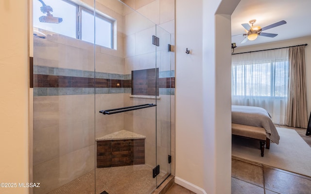 ensuite bathroom featuring plenty of natural light, a stall shower, and a ceiling fan