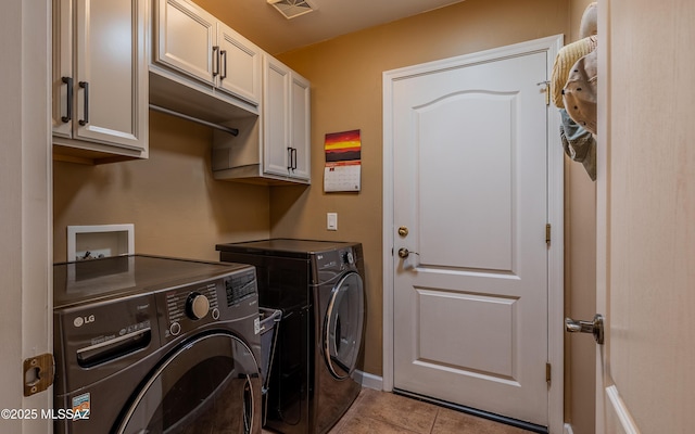 clothes washing area featuring washer and clothes dryer, light tile patterned floors, cabinet space, and visible vents