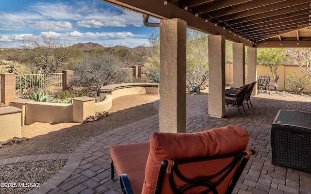 view of patio with a mountain view and a fenced backyard