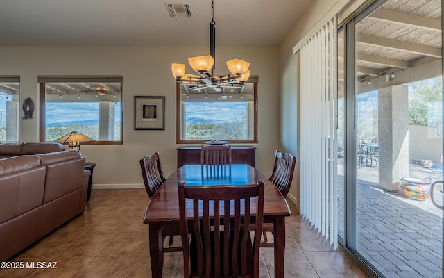 tiled dining space featuring a notable chandelier, visible vents, and baseboards