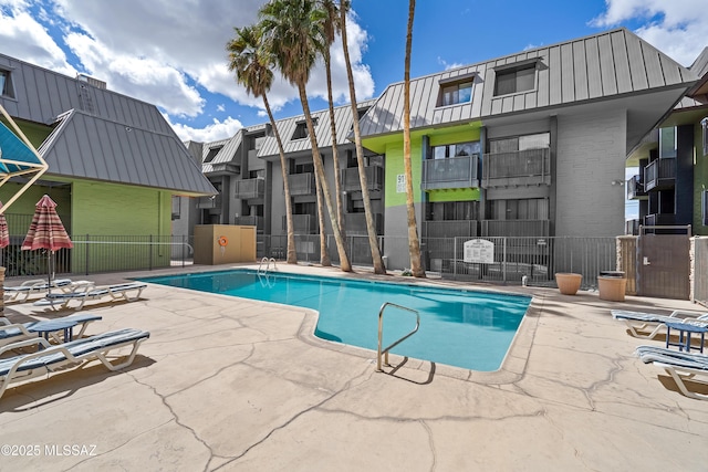 community pool featuring a patio and fence