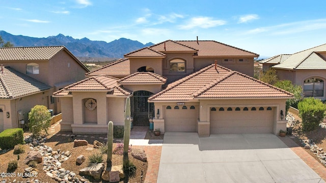 mediterranean / spanish-style home with a tile roof, concrete driveway, a garage, and stucco siding