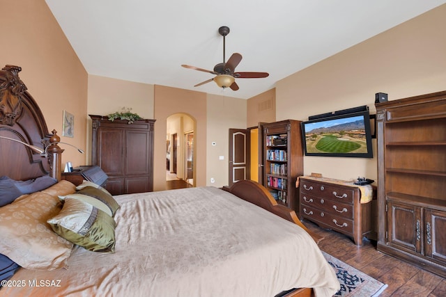 bedroom featuring visible vents, arched walkways, dark wood-type flooring, and ceiling fan