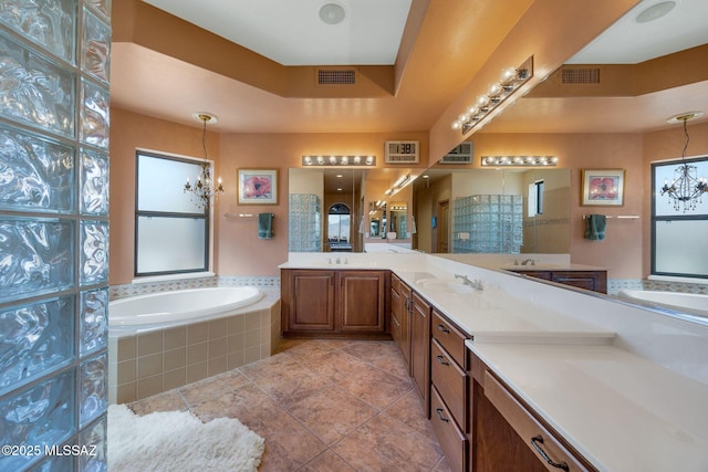 bathroom with a bath, a healthy amount of sunlight, and visible vents