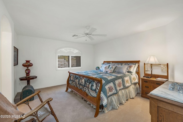 bedroom with a ceiling fan, visible vents, and light carpet