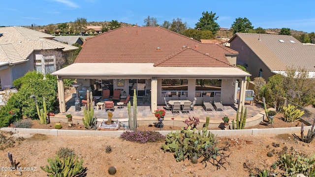 back of house featuring a patio, a tiled roof, and fence