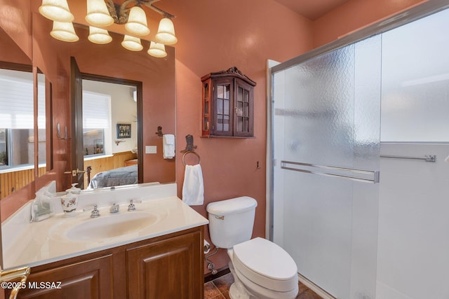 bathroom featuring a stall shower, toilet, ensuite bathroom, and vanity