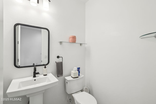 bathroom featuring toilet and a sink