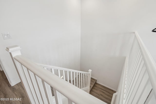 stairway with baseboards and wood finished floors