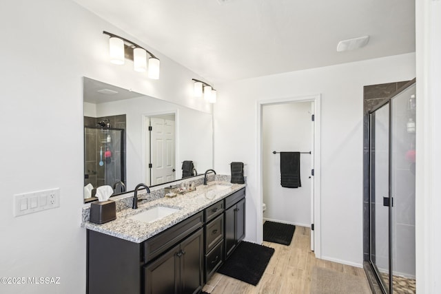 bathroom featuring a shower stall and a sink