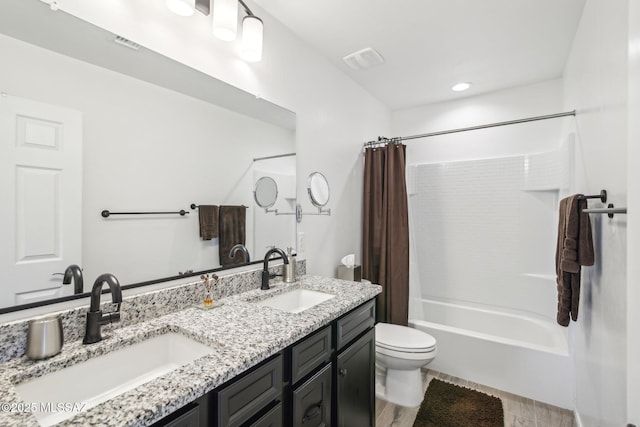 full bath with a sink, visible vents, toilet, and shower / bath combination with curtain