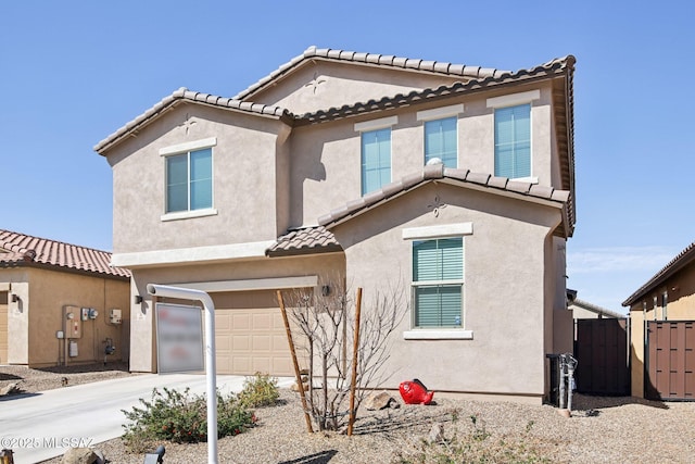 view of front facade featuring fence, a garage, driveway, and stucco siding