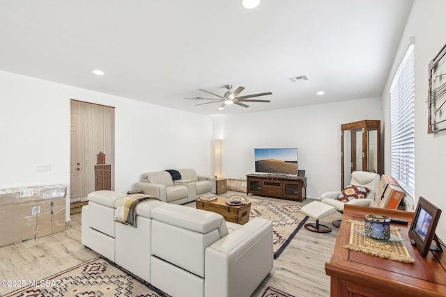 living room with recessed lighting, light wood-style floors, and visible vents