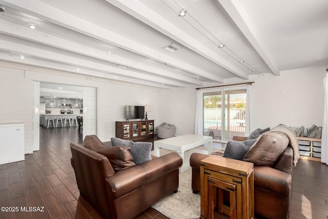 living room featuring dark wood-style floors, beamed ceiling, and visible vents