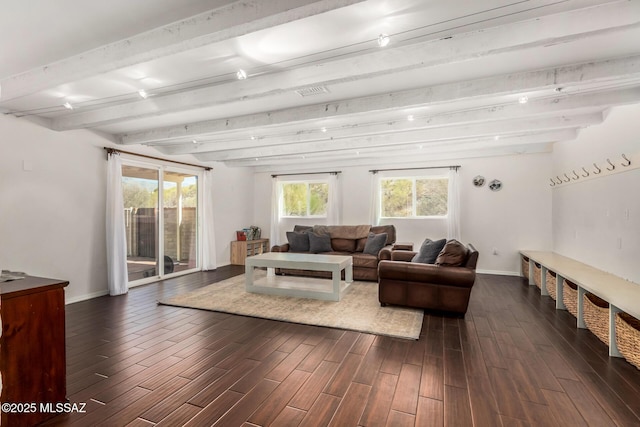 living room featuring plenty of natural light, beam ceiling, and dark wood finished floors