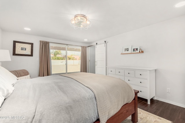 bedroom featuring a barn door, baseboards, dark wood-style flooring, access to exterior, and recessed lighting