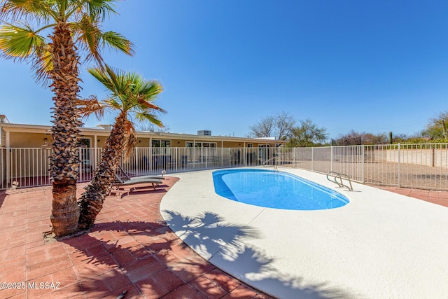 view of swimming pool with a patio area, fence, and a fenced in pool