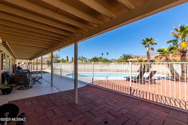 view of patio with fence and a fenced in pool