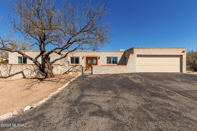 view of front of home featuring a garage and brick siding