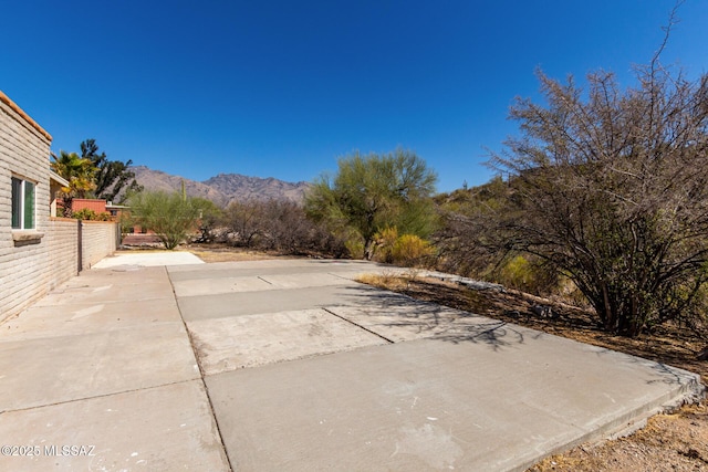 exterior space with fence and a mountain view