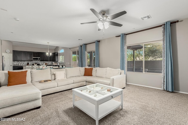living room with light carpet, a ceiling fan, visible vents, and baseboards