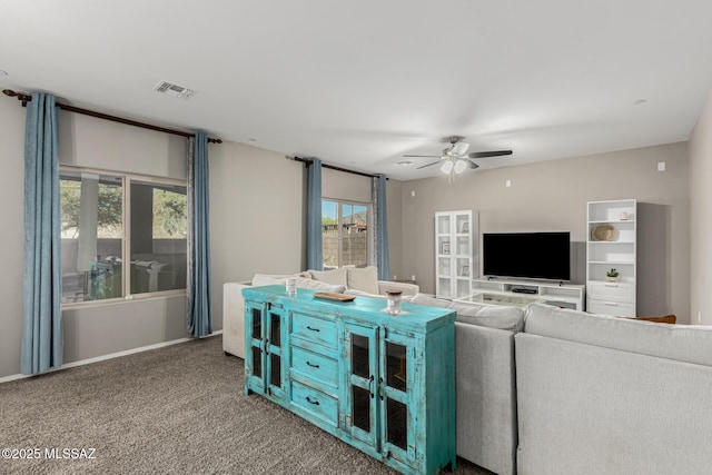 carpeted living room featuring ceiling fan and visible vents