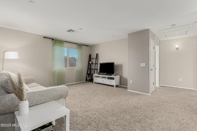 carpeted living area featuring visible vents and baseboards