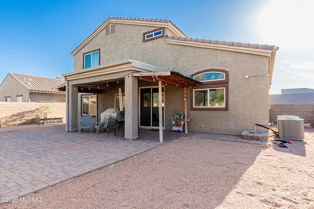 back of house featuring a patio, a tiled roof, fence, central air condition unit, and stucco siding