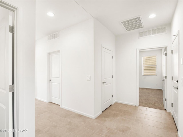 hall with light tile patterned floors, recessed lighting, and baseboards