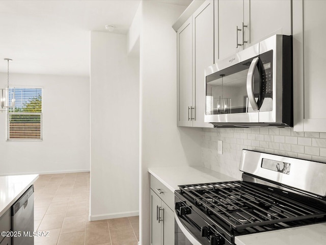 kitchen with appliances with stainless steel finishes, decorative backsplash, and light countertops