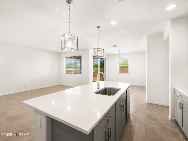 kitchen featuring a sink, gray cabinetry, recessed lighting, light tile patterned flooring, and pendant lighting