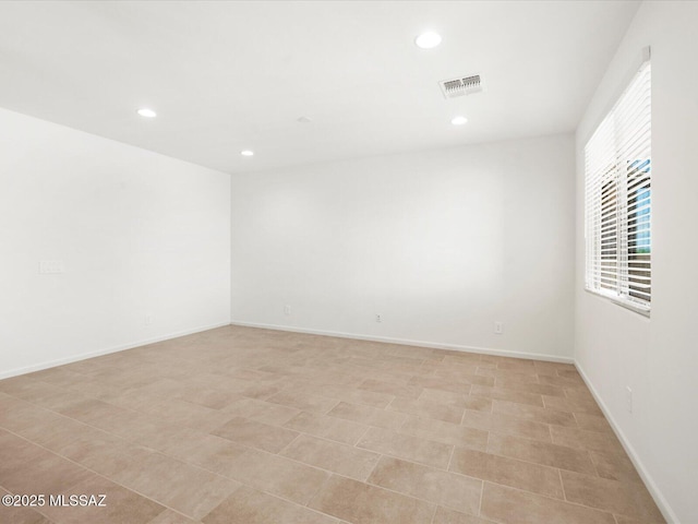 unfurnished room featuring recessed lighting and baseboards