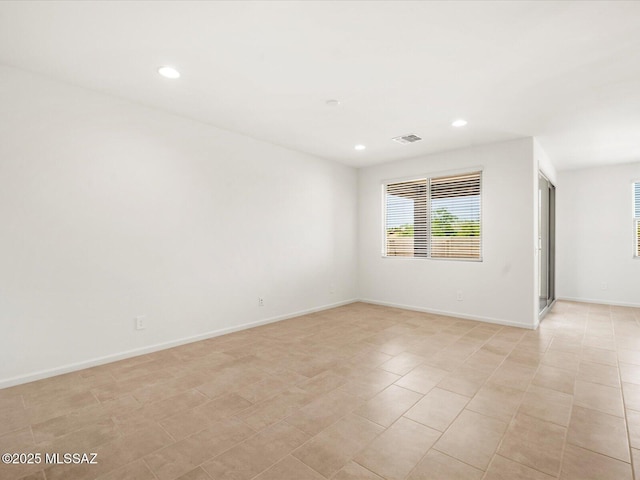 empty room with recessed lighting and baseboards