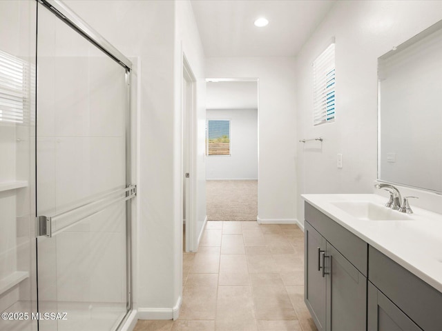 full bath with a stall shower, baseboards, vanity, tile patterned floors, and recessed lighting