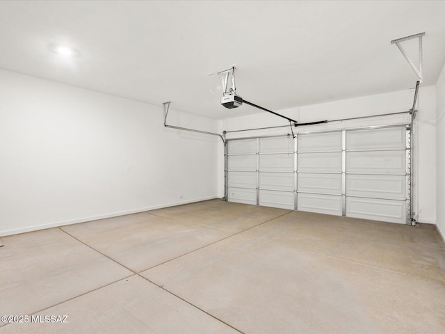 garage featuring a garage door opener and baseboards