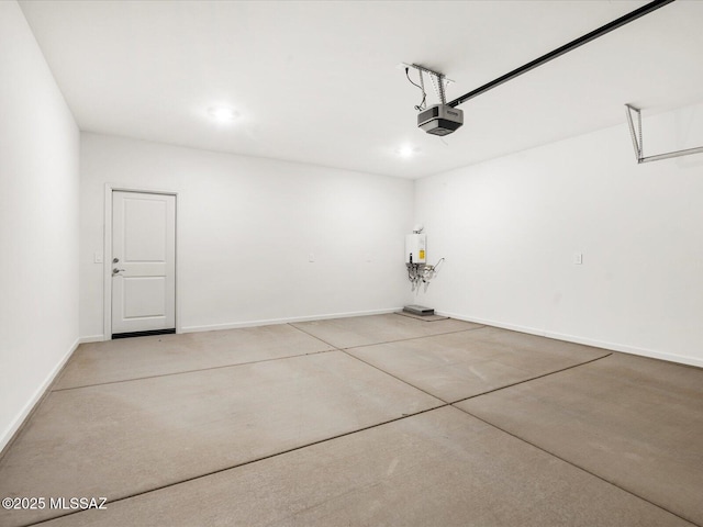 garage featuring a garage door opener, recessed lighting, and baseboards