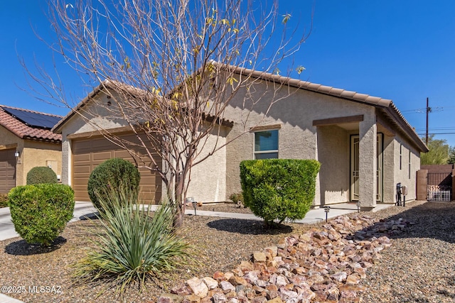 view of home's exterior featuring a garage, a tile roof, and stucco siding