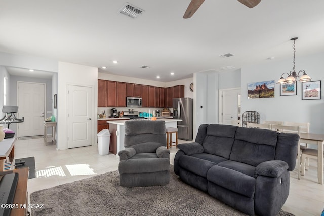 living area featuring ceiling fan with notable chandelier, light tile patterned flooring, visible vents, and recessed lighting