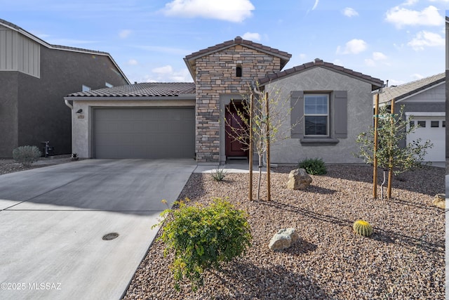 view of front of property featuring an attached garage, stone siding, a tile roof, and concrete driveway