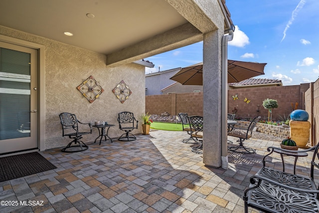 view of patio with outdoor dining space and a fenced backyard