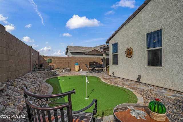 view of yard featuring a patio area and a fenced backyard