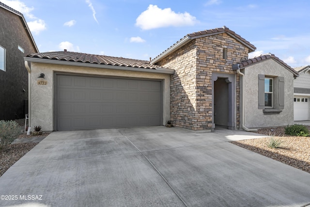 view of front facade featuring an attached garage, stone siding, concrete driveway, and stucco siding