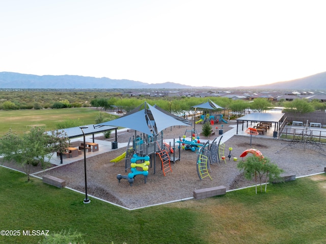 community play area with a mountain view and a yard