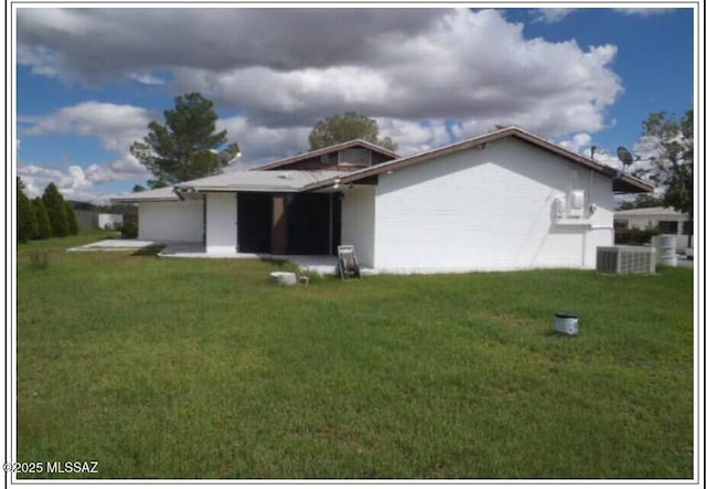 back of property with a yard and cooling unit