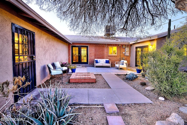 view of patio featuring french doors and an outdoor living space