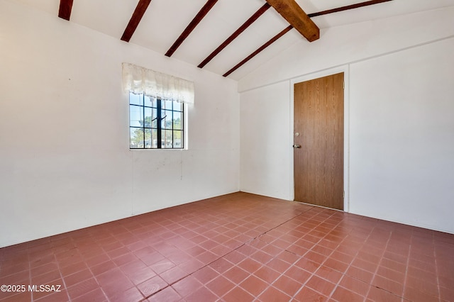 empty room with lofted ceiling with beams