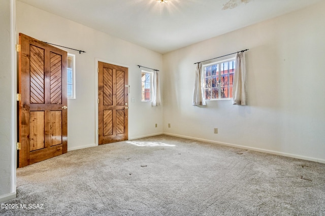 unfurnished bedroom featuring baseboards and carpet flooring