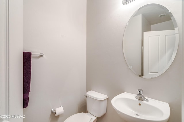 bathroom with toilet and a sink