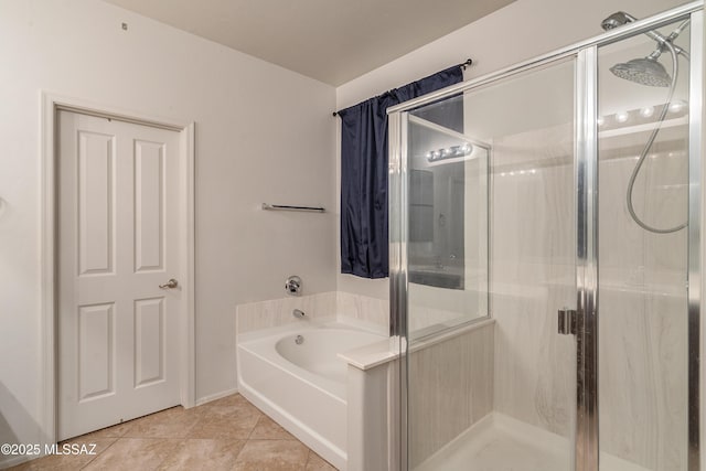 full bath featuring a garden tub, a shower stall, and tile patterned floors