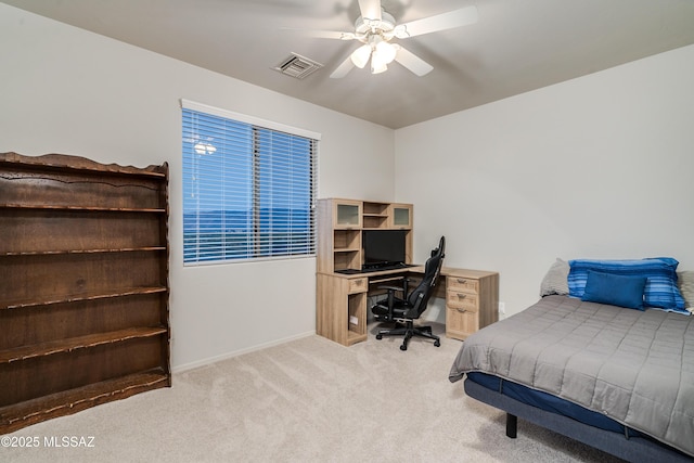 carpeted bedroom with baseboards, visible vents, and a ceiling fan